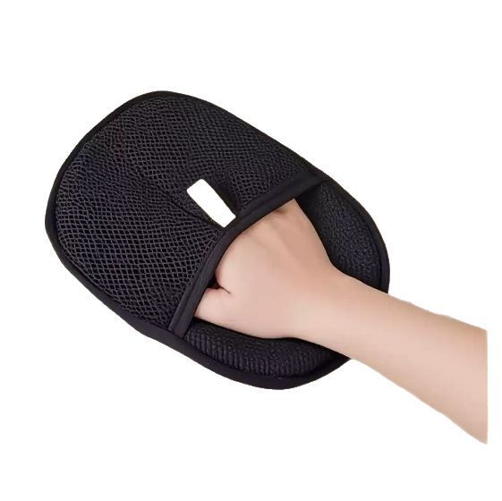 Pet grooming glove worn on a hand